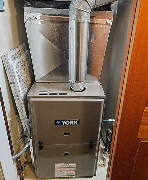 A York furnace fitted in a utility closet